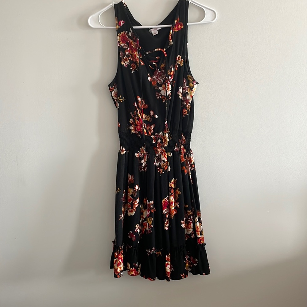Black dress with flowers. Ruffled at the bottom cross tie at the top